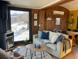 a living room with a couch and a fireplace at Koselig gårdshus in To