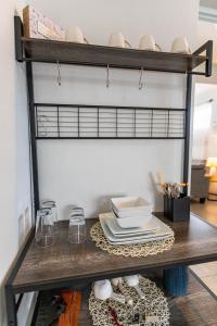 a shelf with plates and dishes on a table at One Bedroom Apartment, Private pool, huge yard in Anasco