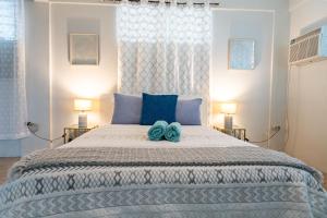 a bedroom with a large bed with blue pillows at One Bedroom Apartment, Private pool, huge yard in Anasco