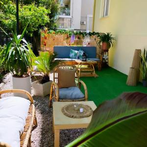 a patio with a couch and chairs and a table at Hotel Villa Pozzi in Cattolica