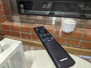 a remote control sitting on top of a table at Ultra-central apartment in the Dauerbach Palace in Timişoara +38 photos