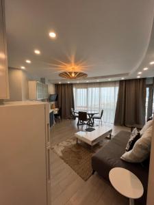 a kitchen and a living room with a couch and a table at Orbi sea towers in Batumi