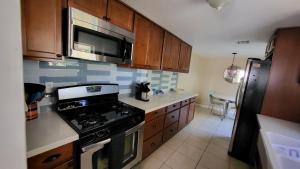 a kitchen with a stove and a microwave at Unit 2 - Stylish 2BR Downtown Phoenix Retreat in Roosevelt Row, Parking Included in Phoenix