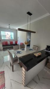 uma sala de estar com uma mesa e um sofá em Casa Arraial do Cabo - Figueira em Arraial do Cabo mais 19 fotografias