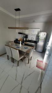uma cozinha com mesa e cadeiras em uma sala em Casa Arraial do Cabo - Figueira em Arraial do Cabo