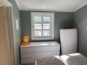 1 dormitorio con ventana, 1 cama y vestidor en Apartment in Tonsberg, en Tønsberg