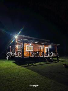 a cabin with a light on top of it at night at Hospedaje la luna in San Miguel del Monte
