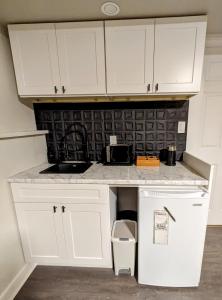 a kitchen with white cabinets and a counter top at By the Sea in Campbell River