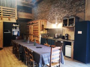 a kitchen with a table and chairs in a room at La Maison Mescladis in Manhac