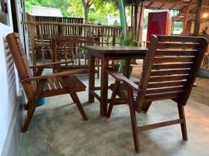 a wooden table and chairs on a patio at The Woodnest in Arugam Bay