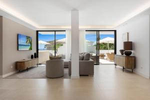 a living room with a couch and a table at 20600 - Luxurious Beachside Villa Near Marbella in Marbella