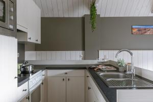 a kitchen with a sink and a counter top at Huswell - Cosy two bedroom apartment in Middelkerke in Middelkerke