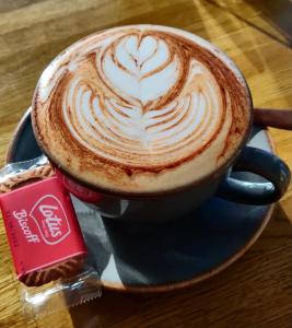 a cup of coffee on a plate on a table at Rooms at The March Hare in Market Rasen