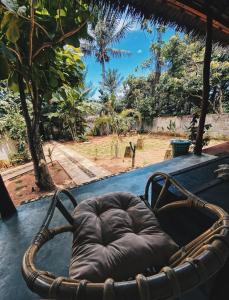 a brown chair sitting on top of a table at Basa-basi Lodge in Karimunjawa