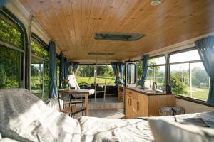 a camper van with a kitchen and a dining area at Bus Ikarus in Prievidza