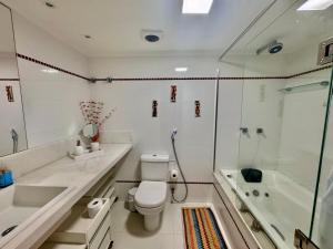 a bathroom with a toilet and a sink and a shower at Ondina Apart Hotel Residences in Salvador