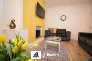 a living room with a couch and a table at Modern 3 bed Terraced House By NYOS PROPERTIES Short Lets & Serviced Accommodation Manchester With Free WiFi in Manchester