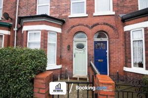 a red brick house with a blue door at Modern 3 bed Terraced House By NYOS PROPERTIES Short Lets & Serviced Accommodation Manchester With Free WiFi in Manchester