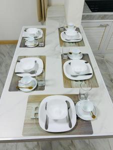 a table with white plates and glasses on it at 93 House in Ban Bang Toei (1)