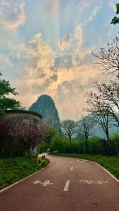 eine leere Straße mit einem Berg im Hintergrund in der Unterkunft The Beyond Villa Guilin in Guilin