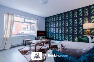 a living room with a couch and a table at 3 Bed House With Parking By NYOS PROPERTIES Short Lets & Serviced Accommodation Manchester in Manchester