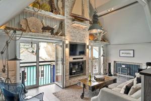 a living room with a couch and a tv at Finest Retreats - The Old Library in Dartmouth