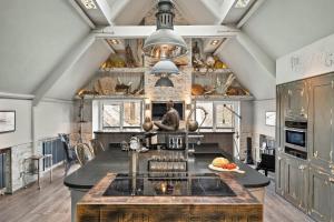a kitchen with a large island in the middle at Finest Retreats - The Old Library in Dartmouth
