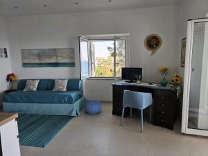 a room with a desk and a bed and a computer at Naturoasi Resort in Belvedere Marittimo