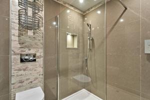 a bathroom with a glass shower with a toilet at Finest Retreats - The Old Library in Dartmouth +14 photos
