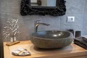 a bathroom sink with a large stone bowl at Ma Maison in Pian Nava +55 photos