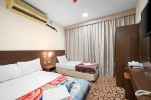 Postel nebo postele na pokoji v ubytování Najiba Hotel