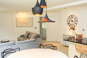 a living room with a couch and a table at CLOSE TO BEACH, dogs welcome, private garden in St Merryn