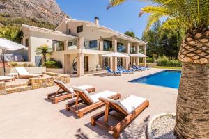 an exterior view of a villa with a swimming pool at Casa Tranquila in Jávea