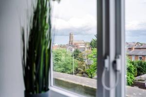 a window with a view of a city at Southport Suites apartment 8 in Southport