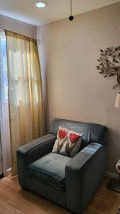a couch with two pillows on it in a living room at U3 - Comfortable 1 BR & 1 BA APT in DT PHX with pkg in Phoenix
