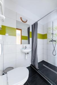 a white bathroom with a sink and a toilet at Sleep&Go in Lubliniec