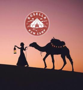 a silhouette of a woman and a camel in the desert at Rosella rum camp in Wadi Rum