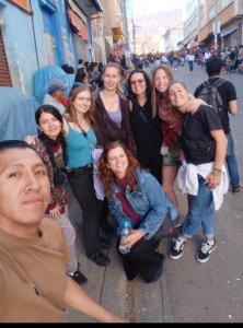 a group of women standing on a city street at SAINT PETER'S LLAMA HOSTAL in La Paz