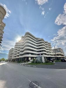 a large white building with a street in front of it at Waves 605 River View in Sarajevo