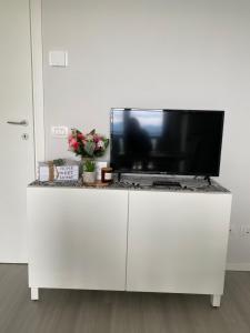 a tv sitting on top of a white cabinet at Dolcevista Apartment in Massino Visconti
