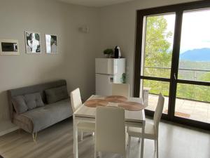 a kitchen and dining room with a table and chairs at Dolcevista Apartment in Massino Visconti