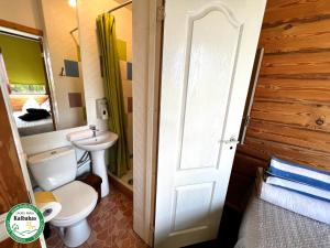 a bathroom with a toilet and a sink at Guest House Kalbakas in Smiltene