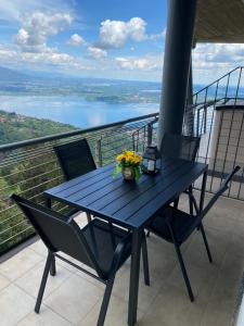 a blue table on a balcony with a view of a lake at TerrazzaDolcevista in Massino Visconti