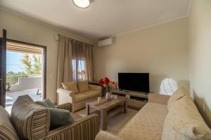 a living room with two couches and a television at Tranquil Retreat in Apokoronas - Chania in Kókkinon Khoríon