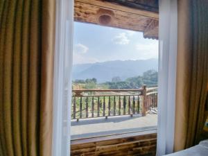 a window view of a balcony with a mountain view at The Mong Garden Hotel in Sa Pa