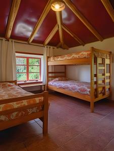 two bunk beds in a room with a ceiling at Casa de Campo con vista al mar in Chanco