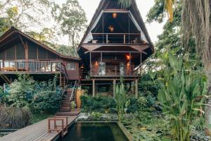 a house with a pond in front of it at Luxury Villa Rainforest Estate with Pond in Bocas del Toro