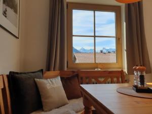 a dining room with a table and a window at Haus Sabine Fewo Bergliebe in Wallgau