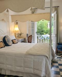 a bedroom with a bed and a patio with a table at Villa Vicuña Salta Hotel Boutique in Salta