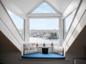 an attic window with a bench in front of it at The Wheelhouse in Fowey